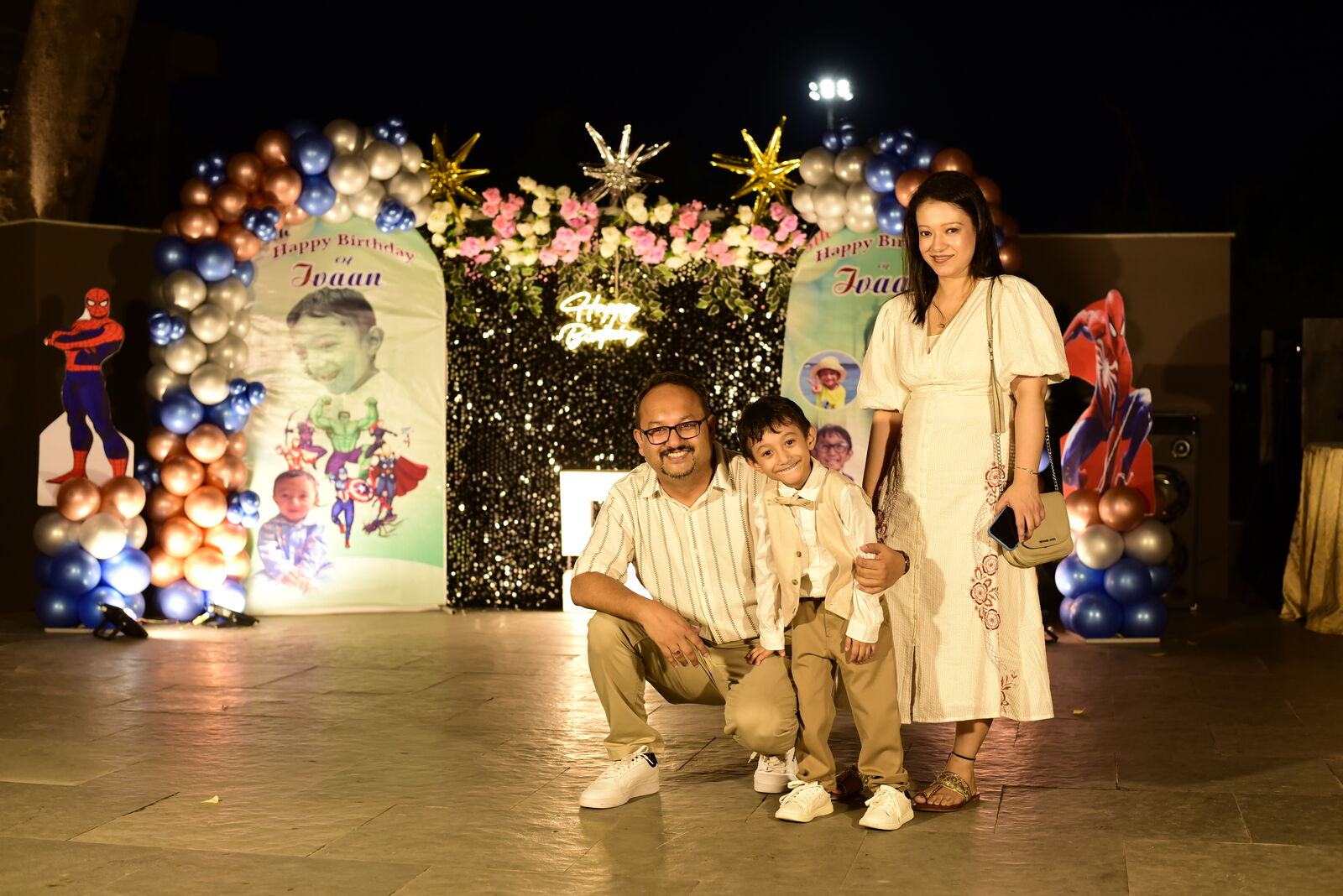 Family posing at the decorated photo backdrop