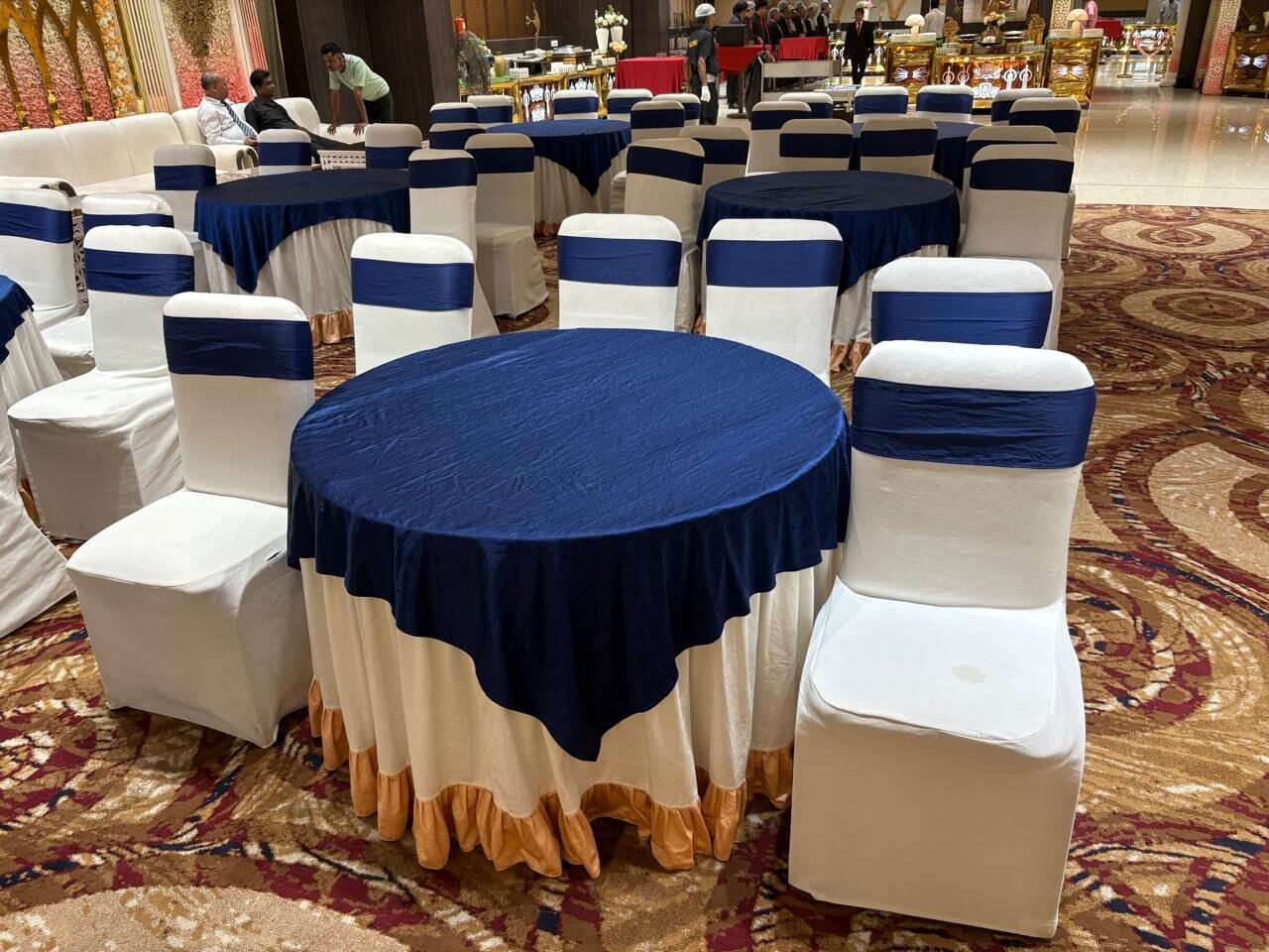 Round banquet tables dressed in navy and white for the gala dinner